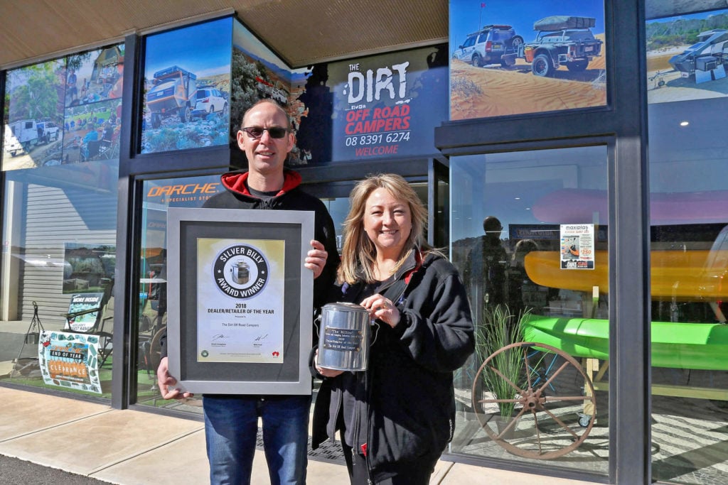 Mike and Anita Pavey with an award at the showroom entrance