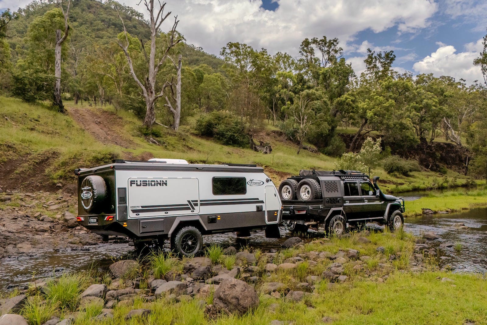 Lifestyle Fusionn crossing a muddy creek behind a 4WD