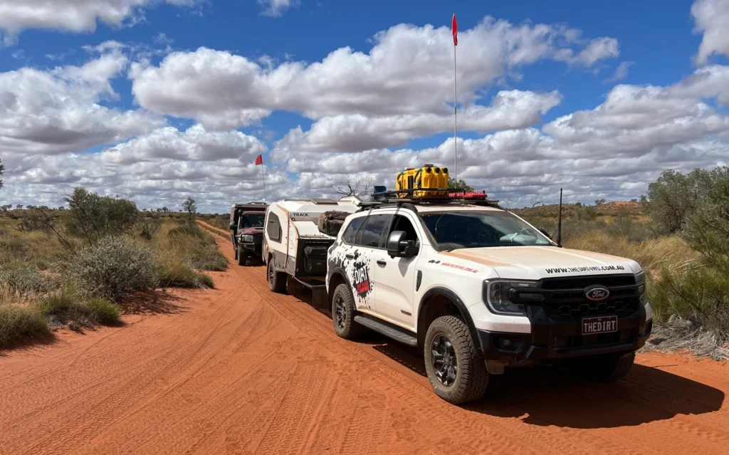 Ford Everest Tremor towing a Track Trailer Mk6 Tvan on the Canning Stock Route, with a loaded roof rack and sand flag.